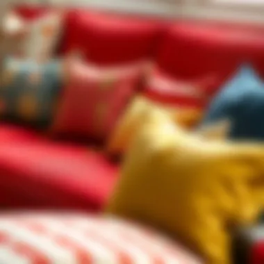 A vibrant array of throw pillows on a red couch showcasing various textures and fabrics.