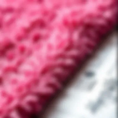 Close-up of texture in a hot pink bath rug