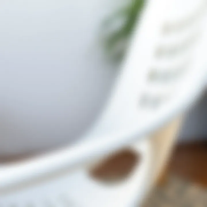 A close-up of the texture and design of a white plastic stacking chair